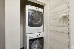 Laundry room featuring stacked washing maching and dryer