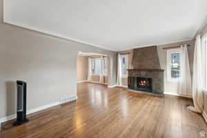 Unfurnished living room featuring a fireplace and wood-type flooring