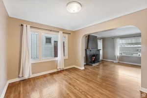 Unfurnished living room with a fireplace, plenty of natural light, and hardwood / wood-style flooring