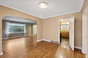 Empty room with sink and light hardwood / wood-style flooring