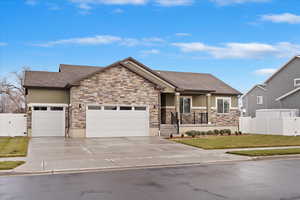 View of front of house featuring a front yard and a garage