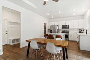 Dining room with ceiling fan, dark hardwood / wood-style floors, and sink