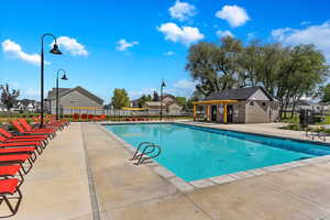 View of swimming pool with an outbuilding and a patio