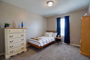 Carpeted bedroom featuring a textured ceiling