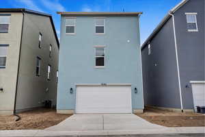 Rear view of property with a garage