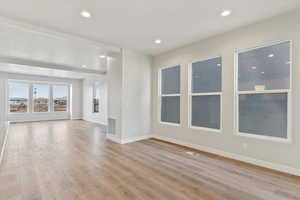 Unfurnished living room featuring light wood-type flooring