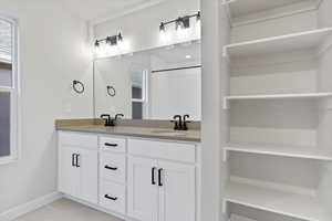 Bathroom featuring tile patterned flooring and vanity