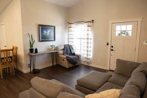 Living room with dark wood-type flooring