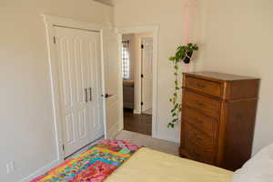 Carpeted bedroom featuring a closet