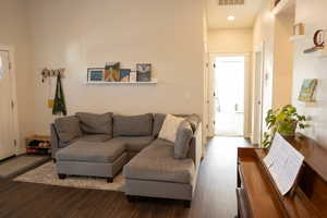 Living room with dark wood-type flooring