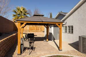 View of patio with a gazebo, grilling area, and central AC unit