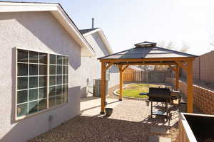 View of patio with a gazebo and central AC