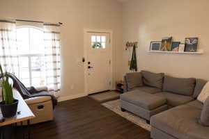 Living room with dark hardwood / wood-style flooring