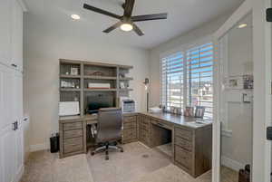 Carpeted office space with ceiling fan