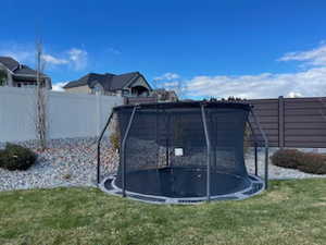 View of yard featuring a trampoline