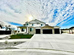 View of front of home with a garage and a front lawn