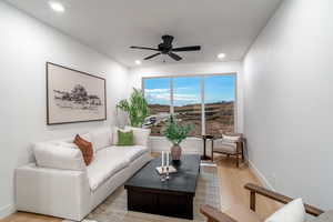 Living room featuring ceiling fan and laminate flooring