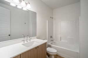 Full bathroom featuring vanity, toilet, and shower / washtub combination