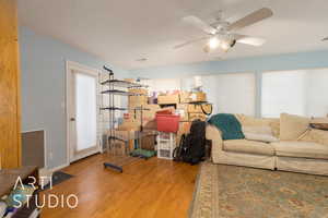 Living room with ceiling fan and light wood-type flooring