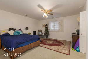 Carpeted bedroom with ceiling fan