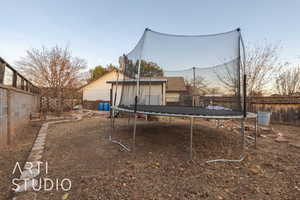 Yard at dusk with a trampoline