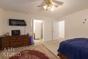 Carpeted bedroom with ceiling fan