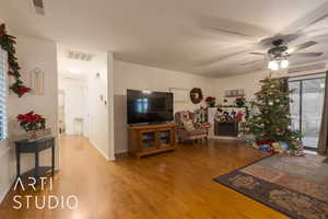 Living room with hardwood / wood-style floors and ceiling fan