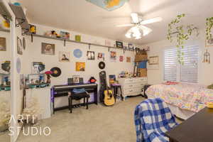 Bedroom with light colored carpet and ceiling fan