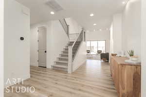 Stairway featuring hardwood / wood-style floors