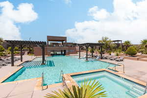 View of swimming pool featuring a pergola, a patio, and a hot tub