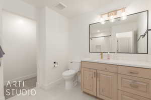 Bathroom featuring a shower with curtain, vanity, and toilet. Ensuite Bedroom #5.