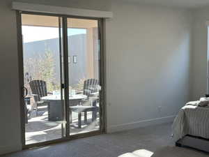 Primary bedroom with access to outside and multiple windows