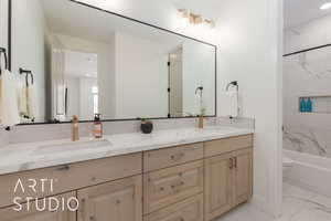 Full bathroom featuring vanity, toilet, and tiled shower / bath combo. Ensuite bedroom #2.