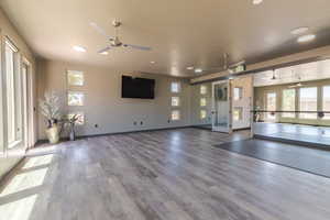 Exercise area with hardwood / wood-style floors