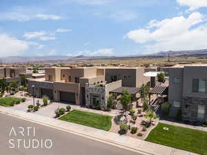 View of front of house with a mountain view and a garage