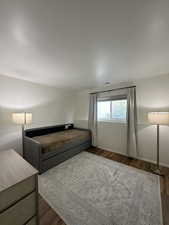 Unfurnished bedroom featuring dark wood-type flooring