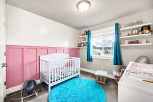 Bedroom with carpet floors and a nursery area