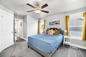 Carpeted bedroom with ceiling fan