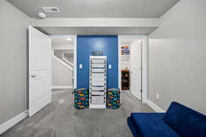 Carpeted bedroom with closet