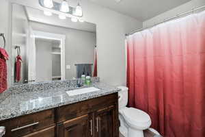 Bathroom featuring vanity and toilet