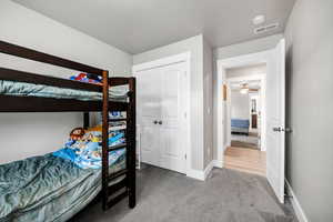 Carpeted bedroom with a closet