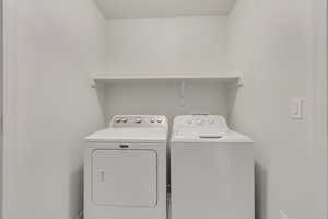 Laundry room with washer and clothes dryer