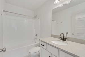 Full bathroom with shower / tub combination, vanity, and toilet