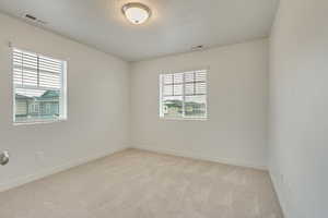 Empty room with light colored carpet