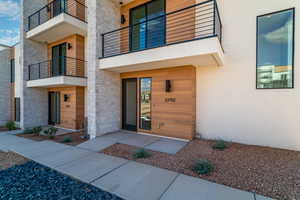 View of exterior entry featuring a balcony