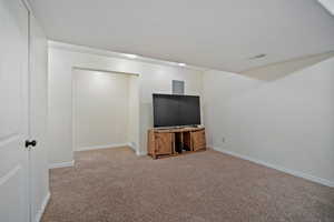 Unfurnished living room featuring carpet floors