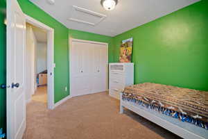 Bedroom with a closet and light colored carpet