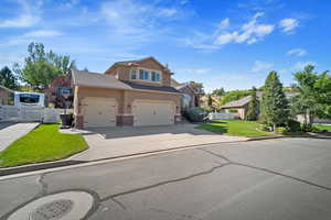 View of front of property featuring a garage and a front lawn