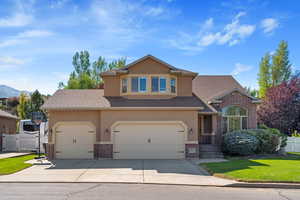 View of front of house with a front yard and a garage