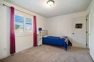 Bedroom with light colored carpet